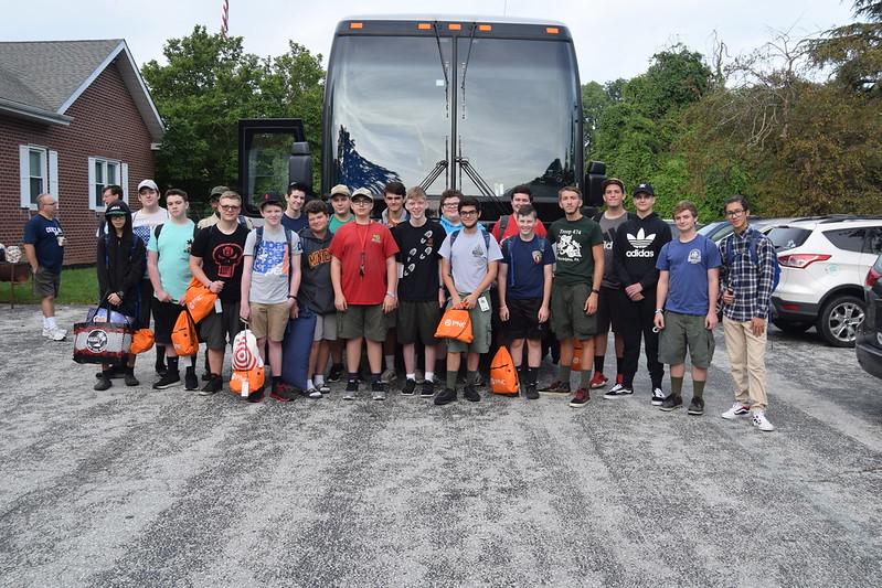 Group of 50 standing in front of a coach bus