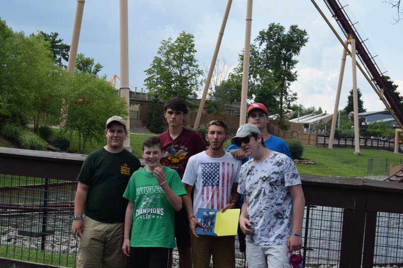 Group standing in front of a rollercoaster